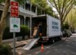 Moving truck parked on a leafy Randwick street beside parking permit and no stopping signs
